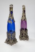 A pair of Victorian coloured glass decanters with silver plated stoppers and mounts, 38cm high