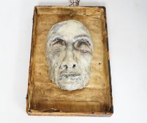 A wax covered plaster "Death Mask", inset within a frame, overall measurement 36cm high x 23cm wide