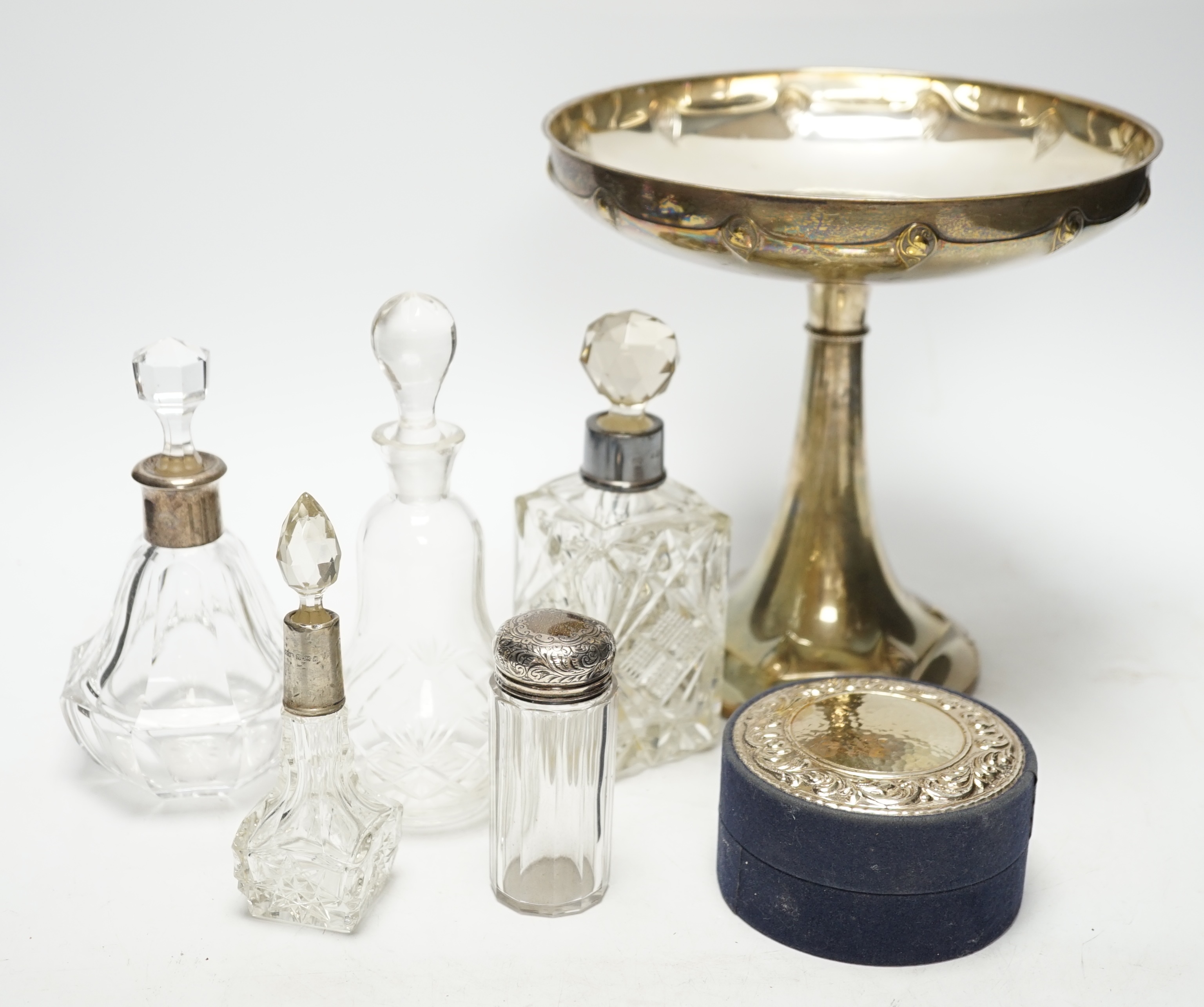 A WMF tazza, 21cm high, and five bottles, two with silver collars, and a cylindrical box