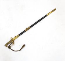 A World War I naval sword with folding guard engraved J.W. Collett R.N., regulation gilt hilt and