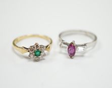 An 18ct, emerald and diamond set flower head cluster ring, size N and an 18ct white metal ruby and