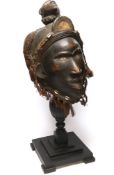 A West African carved wood helmet mask, possibly Kuba (Democratic Republic of Congo), with applied