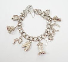 A modern silver charm bracelet, hung with nine assorted charms.