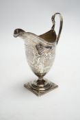 A George III engraved silver helmet shaped cream jug, on square foot, Soloman Hougham, London, 1796,