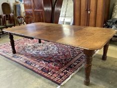 A late Victorian Aesthetic period oak extending dining table, 258cm extended, two spare leaves,
