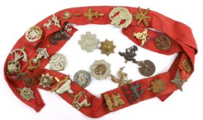 Thirty-two military cap badges, including; The Devonshire Reg., The Buffs, RFC, Royal Artillery, The