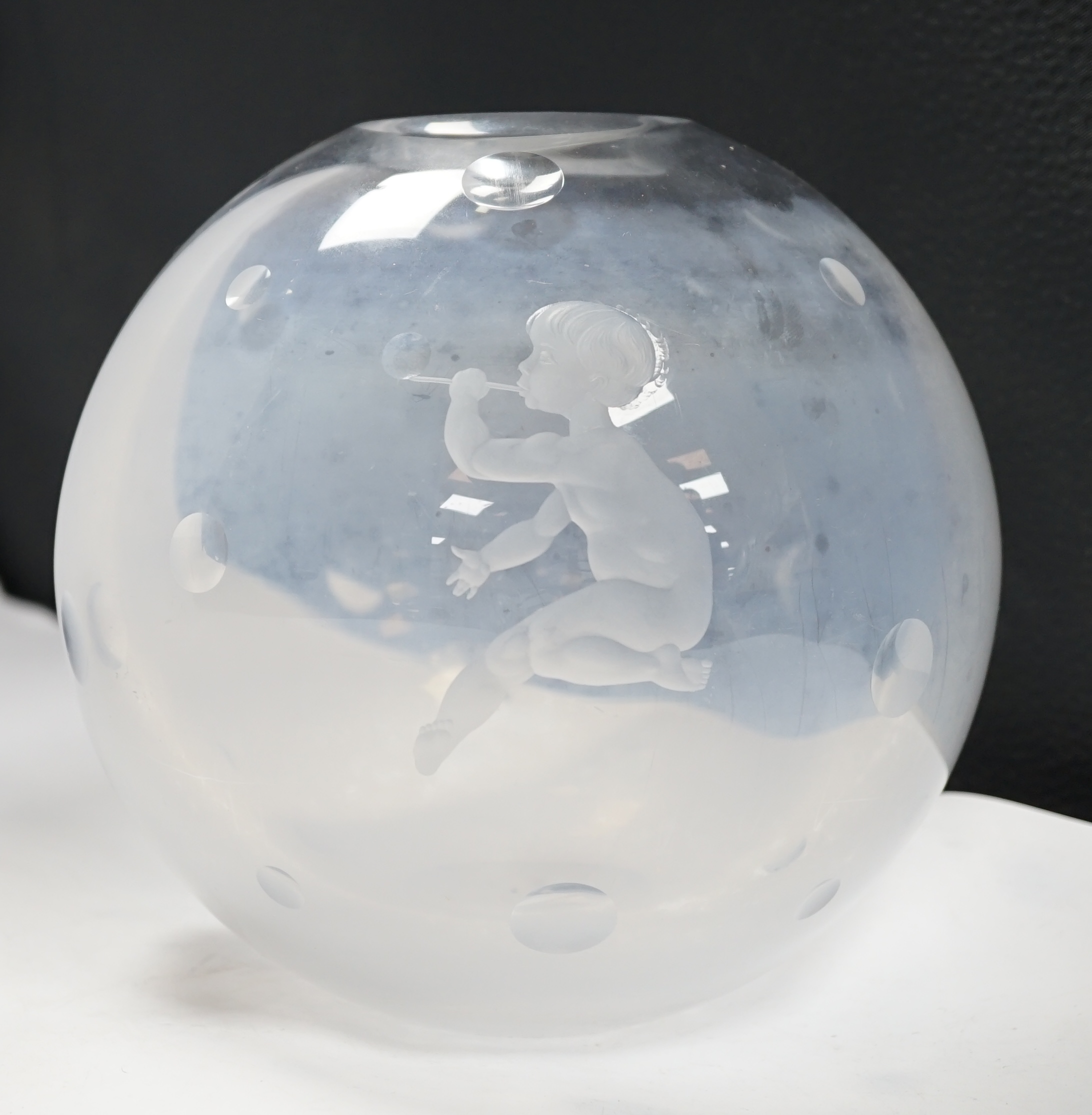 An Orrefors globular glass vase, engraved with a boy blowing bubbles, attributed to Vicke
