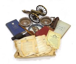 A collection of militaria, including a brass model of a Napoleonic era field gun, a stained glass