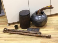 An earthenware bowl, two woven arrow quivers, a bronze pot, a wooden pot and lid, a fertility