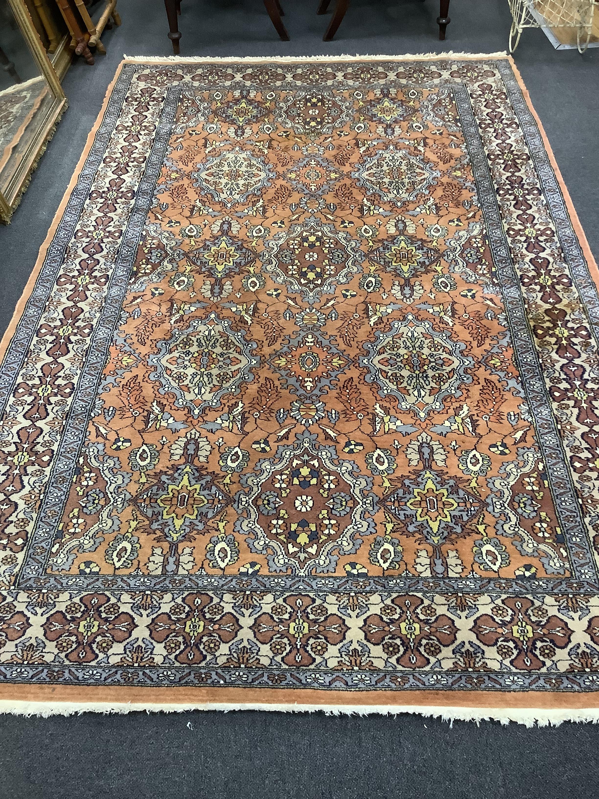 A North West Persian style pale red ground carpet, 250 x 154cm