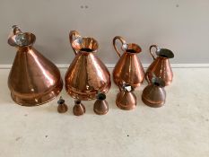 A matched graduated set of nine late 19th / early 20th century copper haystack measures, three