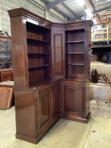 A George III style mahogany corner library bookcase, the mid section incorporating a secret