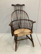 A reproduction American style beech rush seat Windsor comb back armchair, width 64cm, depth 50cm,