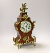 A Louis XV style tortoiseshell and ormolu mounted mantel clock with enamel Roman numeral dial,