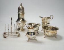 Two 20th century silver cream jugs, two silver sugar bowls, a silver toastrack and a silver