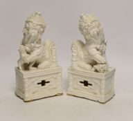 A pair of Chinese blanc de chine lion dogs, 21cm high