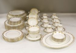 A Wedgwood gilt vine pattern dinner and coffee service for twelve