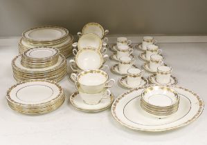 A Wedgwood gilt vine pattern dinner and coffee service for twelve