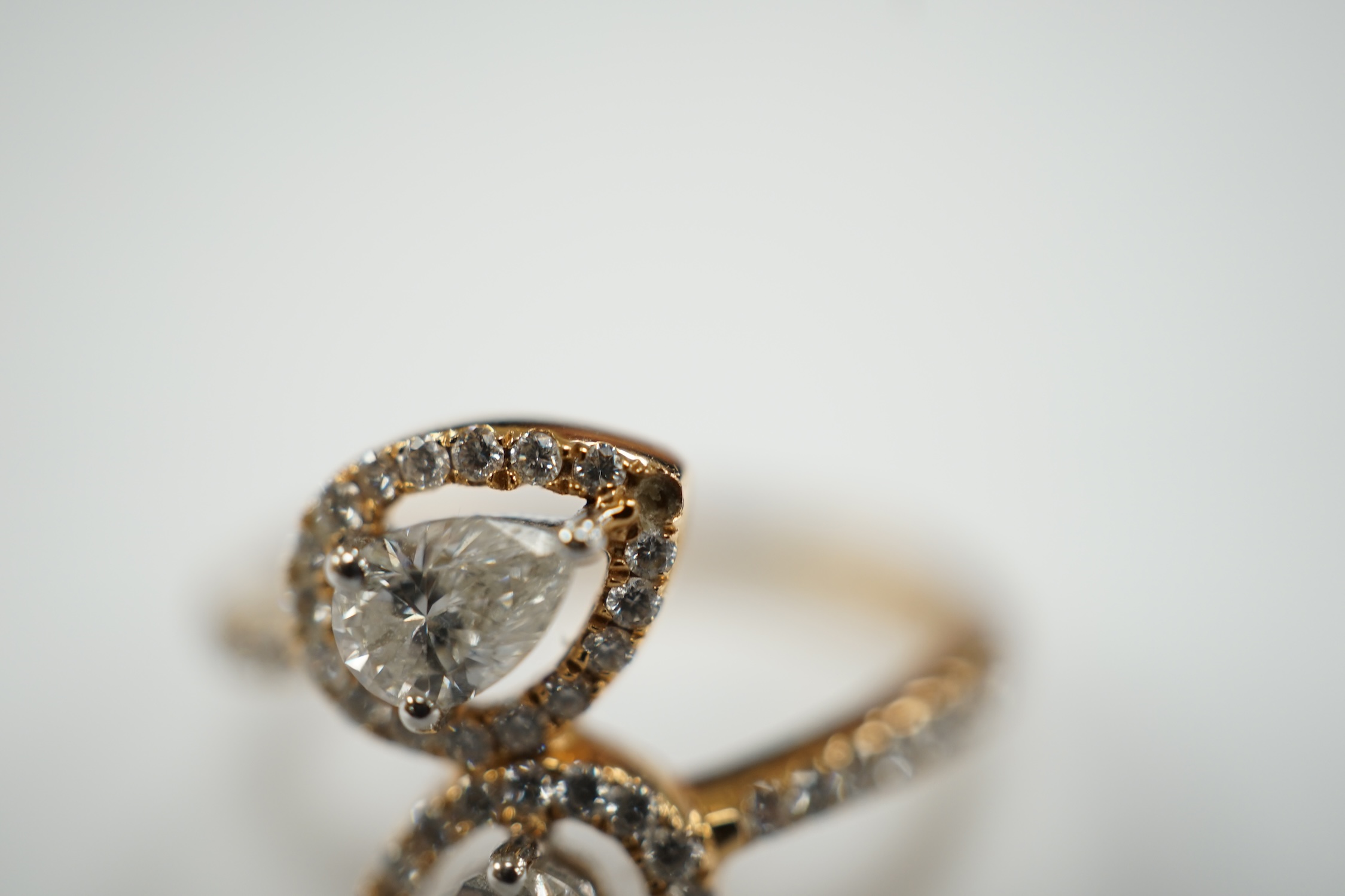A modern 18k and two stone pear cut diamond set cross-over ring, with diamond chip border and - Image 3 of 5