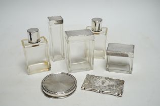 Five assorted silver topped glass toilet jars, a silver compact and an Edwardian engraved silver