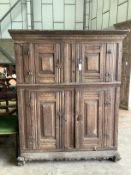 A Continental 17th century style oak four door hardwood cabinet, width 133cm, depth 60cm, height
