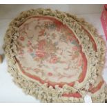 Four 20th century oval floral needleworked cushion covers with tasselled edging, 57cm wide