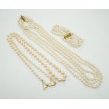 Two Cultured pearl necklaces including a triple strand with yellow metal and sapphire set clasp,