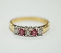 An 18ct gold, two stone pink sapphire? and three stone diamond set half hoop ring, size O, gross
