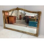 A large Victorian style gilt framed overmantel mirror, width 184cm, height 112cm
