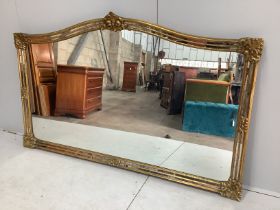 A large Victorian style gilt framed overmantel mirror, width 184cm, height 112cm