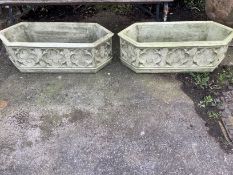 A pair of cast stone Gothic style garden planters of elongated hexagonal form, width 88cm, depth