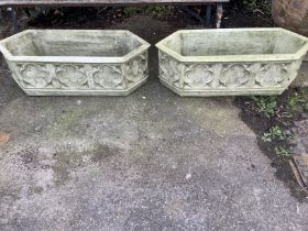 A pair of cast stone Gothic style garden planters of elongated hexagonal form, width 88cm, depth