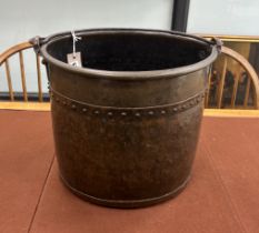 A late Victorian Arts and Crafts hammered copper coal bucket with iron swing handle, diameter