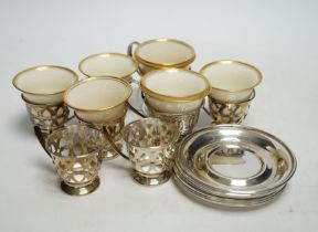 A set of six Limoges Lenox coffee cups with sterling holders and saucers and a pair of larger