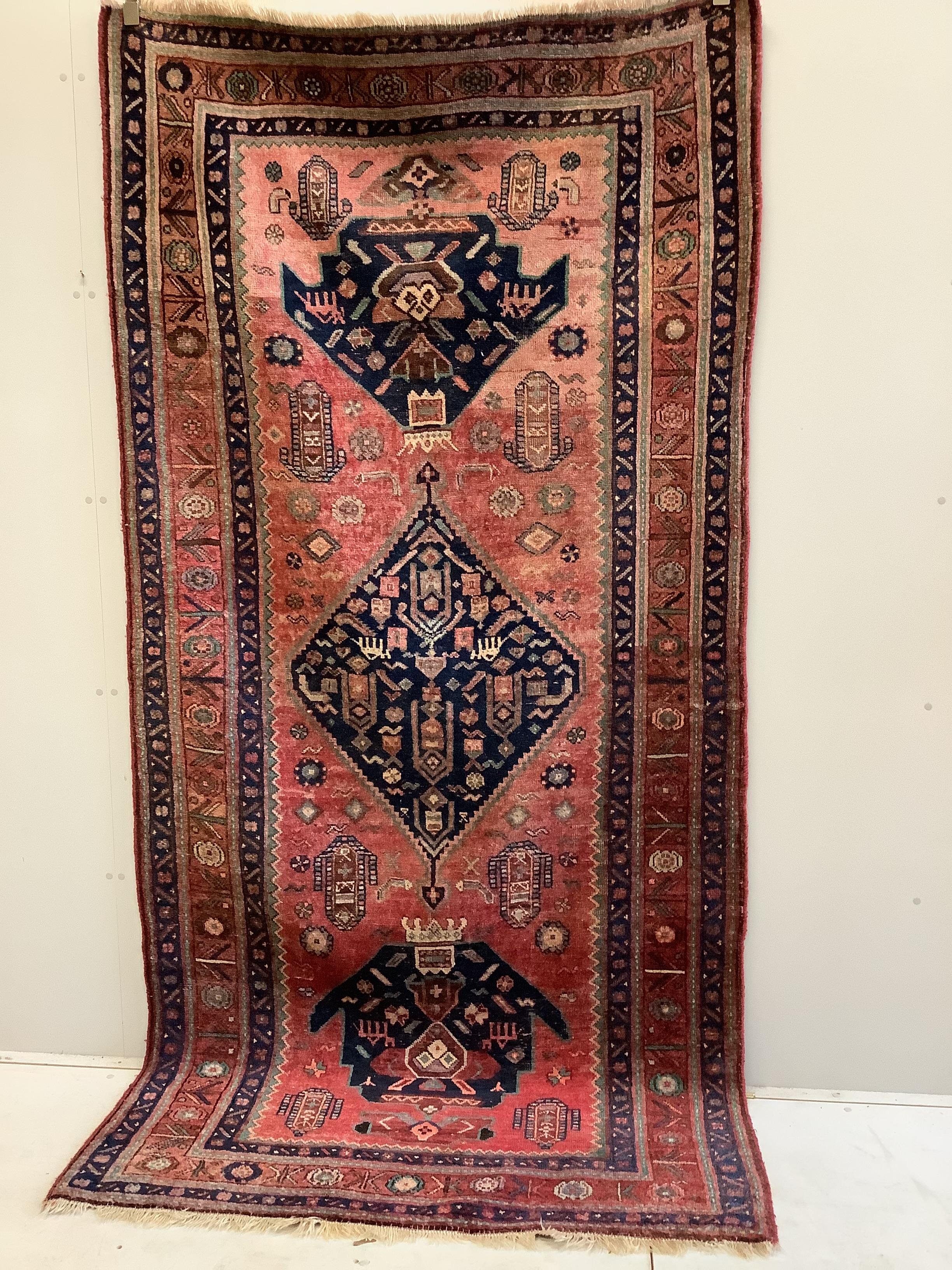 An Heriz red ground medallion rug with triple medallions on a brick red ground, multi bordered, - Image 2 of 7