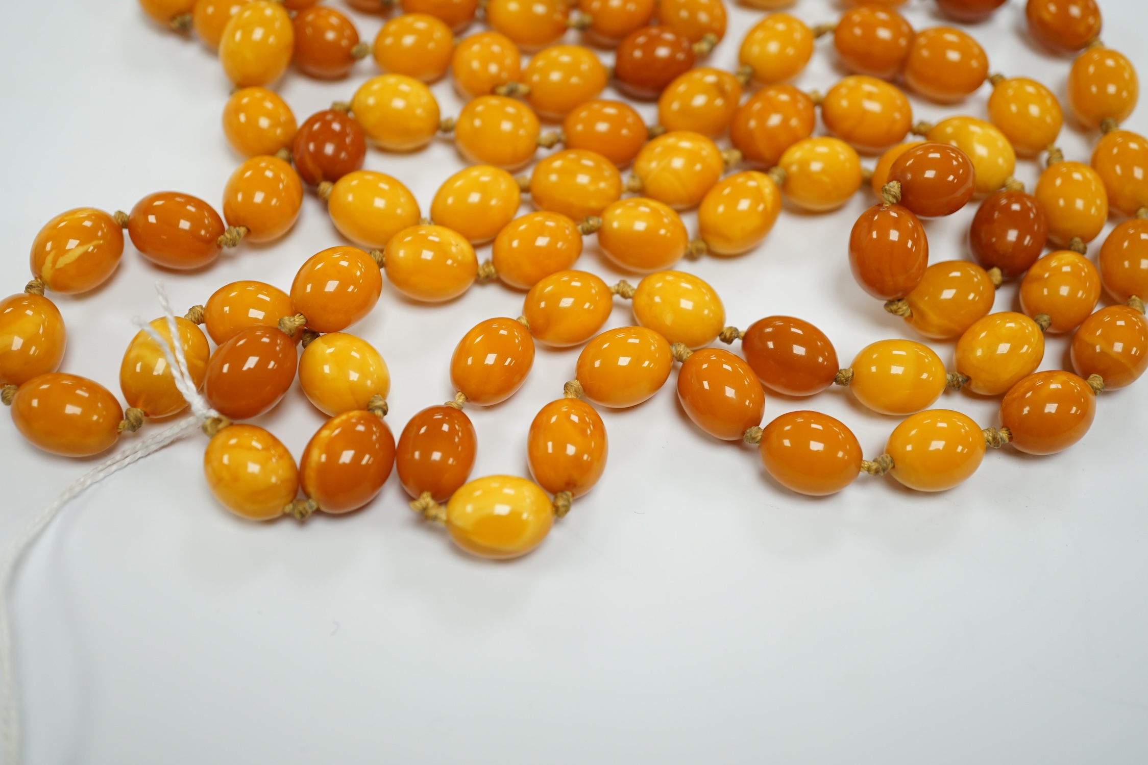 A long single strand oval amber bead necklace, 156cm, gross weight 89 grams. - Image 5 of 9