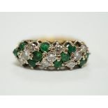 A modern 18ct, emerald and diamond set cluster half hoop ring, size O, gross weight 4.9 grams.