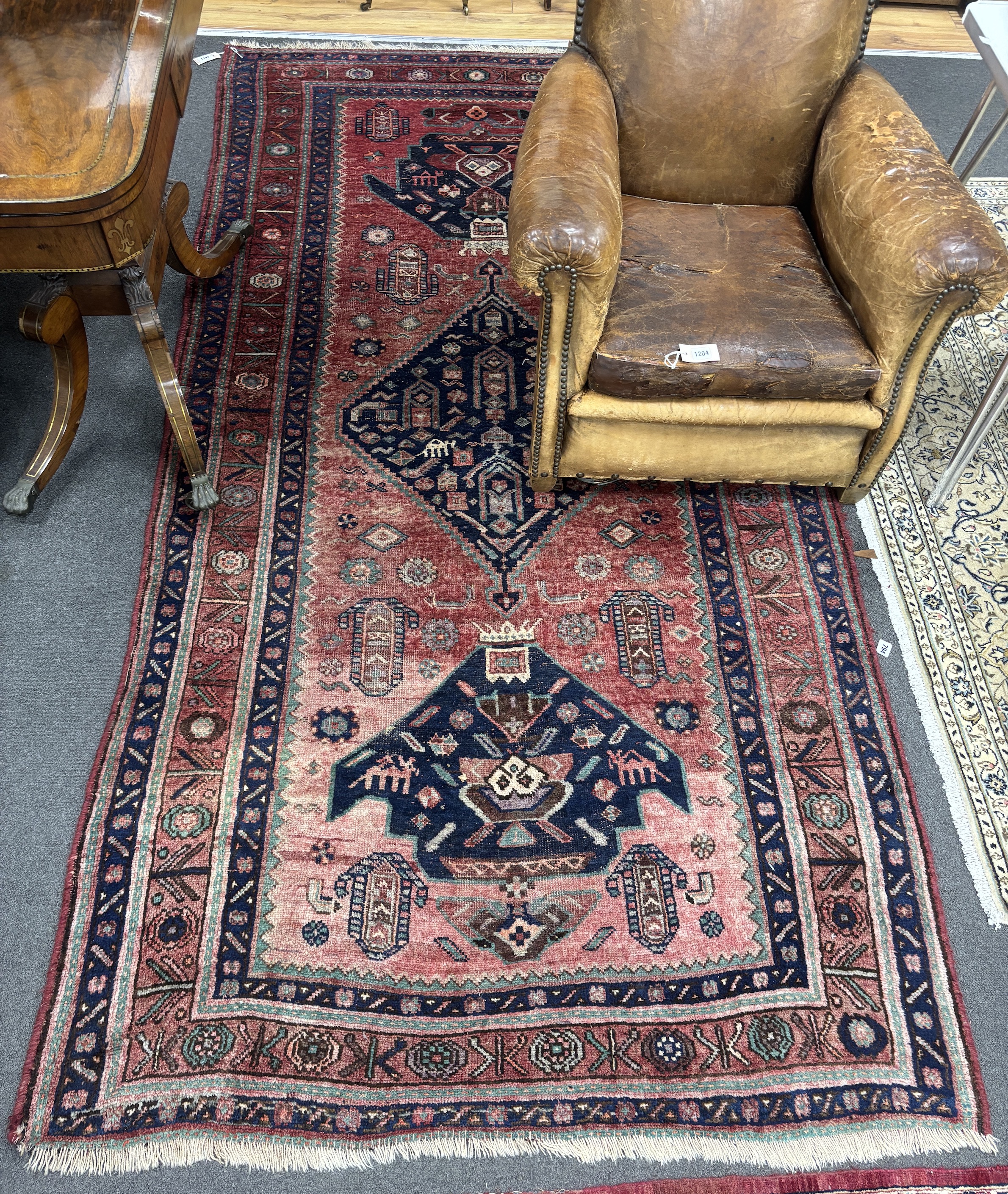 An Heriz red ground medallion rug with triple medallions on a brick red ground, multi bordered, - Image 7 of 7