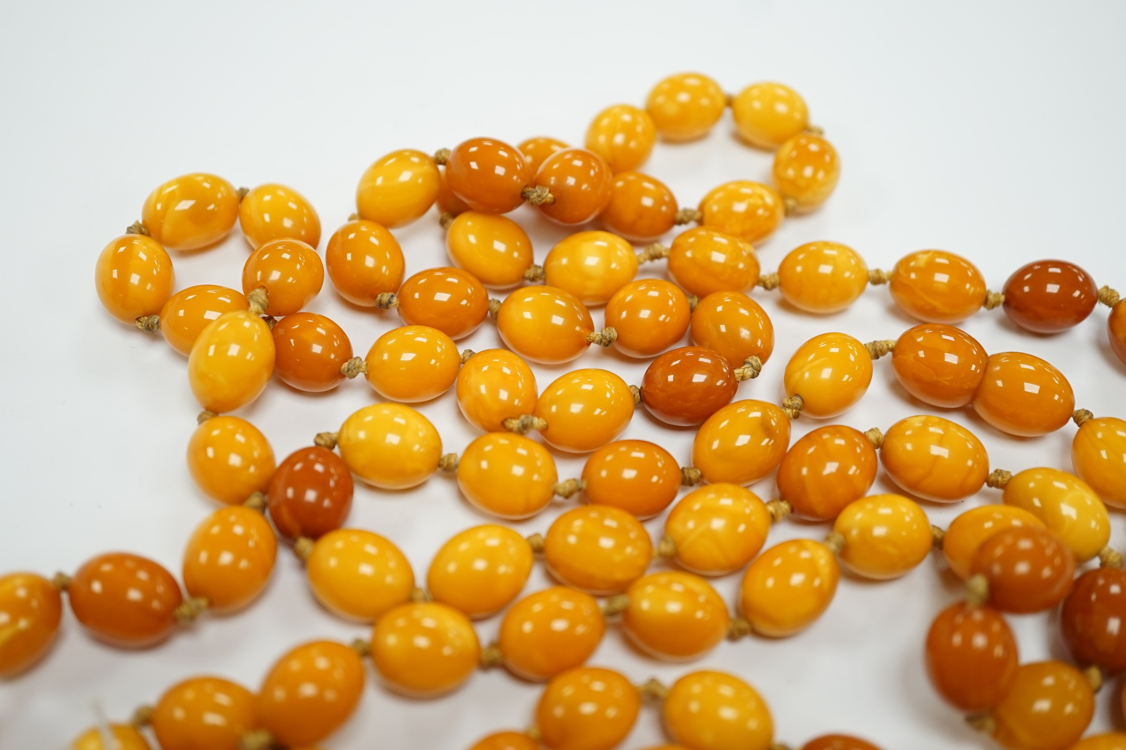 A long single strand oval amber bead necklace, 156cm, gross weight 89 grams. - Image 4 of 9