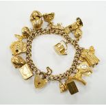 A 9ct gold curb link charm bracelet, with heart shaped padlock clasp and hung with assorted mainly