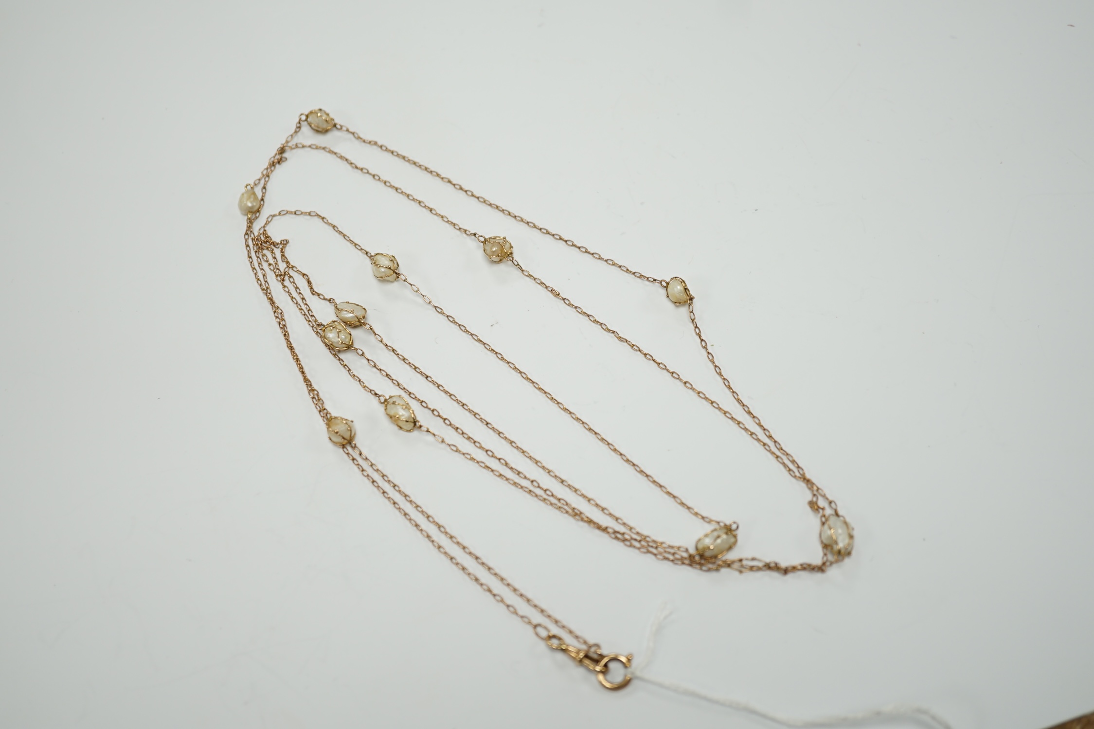 An early 20th century 9ct and eleven stone baroque pearl set long chain, 160cm, gross 13.2 grams. - Image 2 of 5