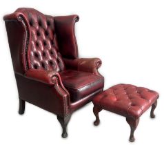 A Victorian style leather armchair, width 82cm, depth 80cm, height 110cm and footstool