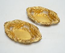 A pair of late Victorian matt finish pierced repousse silver gilt oval dishes, Birmingham, 1897,
