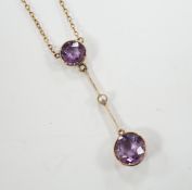 An Edwardian 9ct, two stone amethyst and single stone seed pearl set drop pendant necklace, gross