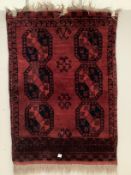 An Afghan red ground rug, 162 x 116cm