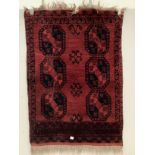 An Afghan red ground rug, 162 x 116cm