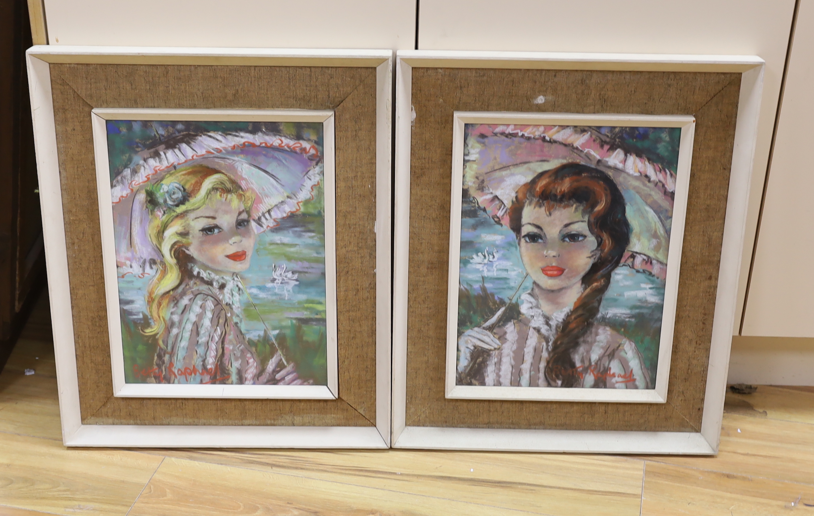 Betty Raphael (20th.C), pair of pastels, Portraits of young women holding parasols, each signed,