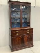 A George III mahogany bookcase cabinet, width 125cm, depth 53cm, height 242cm