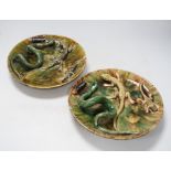 A pair of Palissy style Majolica glazed lizard plates, 23cm in diameter