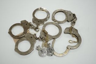 Three handcuffs, two with keys and two Metropolitan Police badges